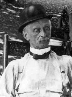 Black and white photo of a man with a mustache wearing a bowler hat, bow tie and white shirt.